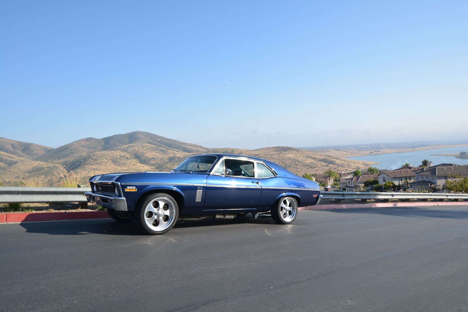 Side profile of a classic car parked at a lookout