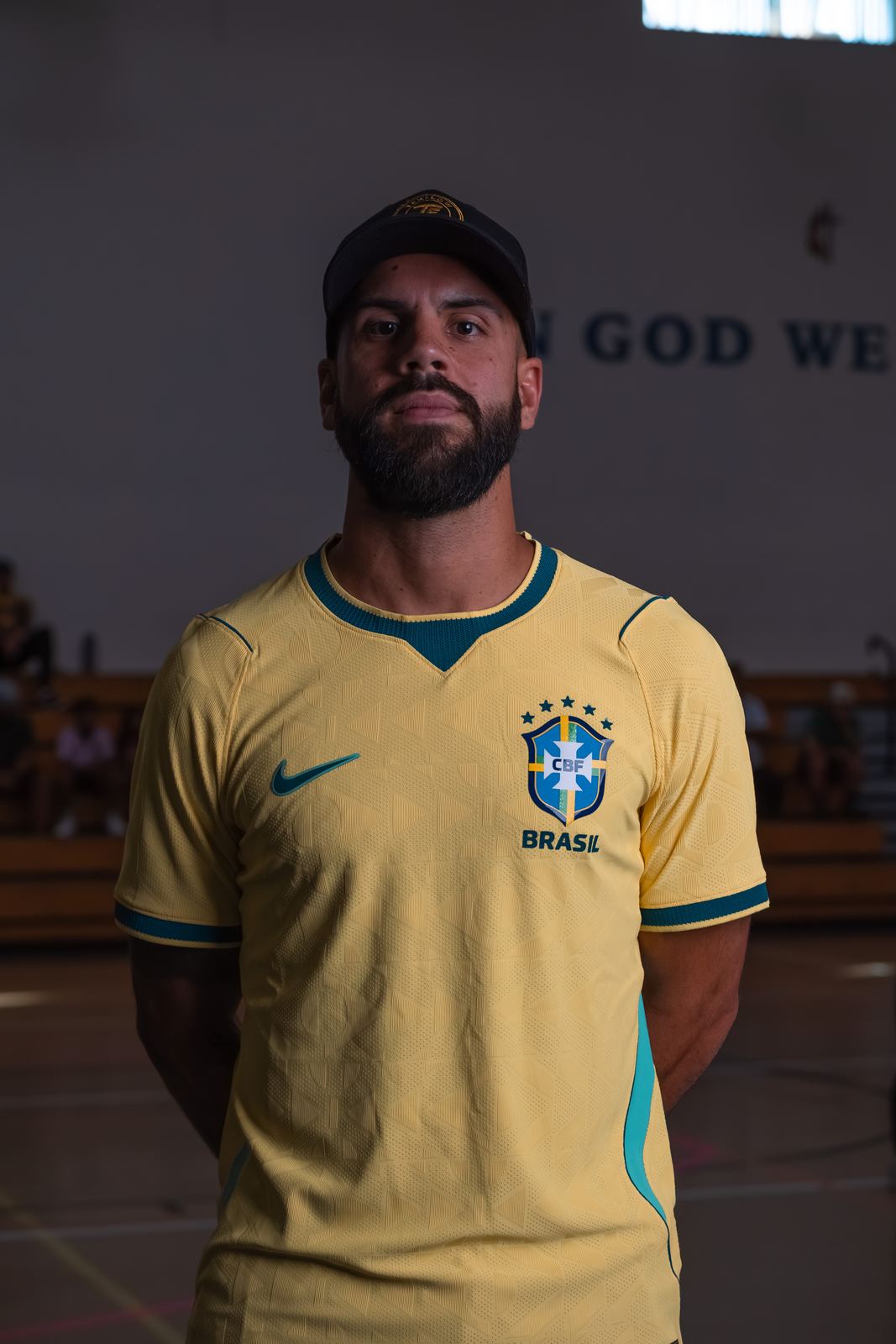 Coach in a yellow jersey, portrait in the gym