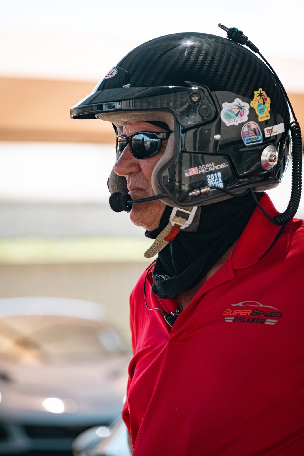 Driver portrait in helmet and red jacket