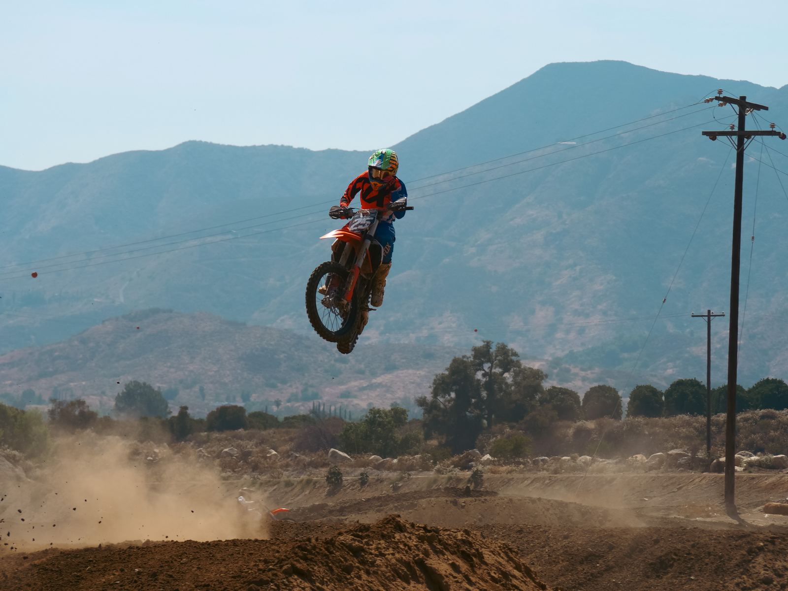 Motocross jump with mountains in the background