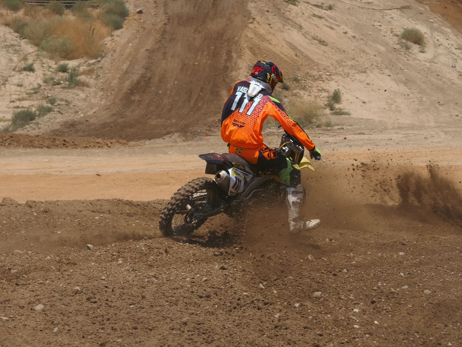 Rider throwing dirt out of a turn