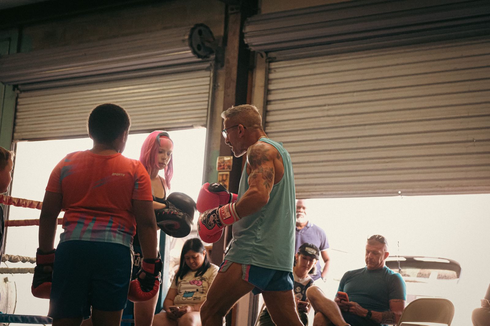 Muay Thai class training together in an open-door gym