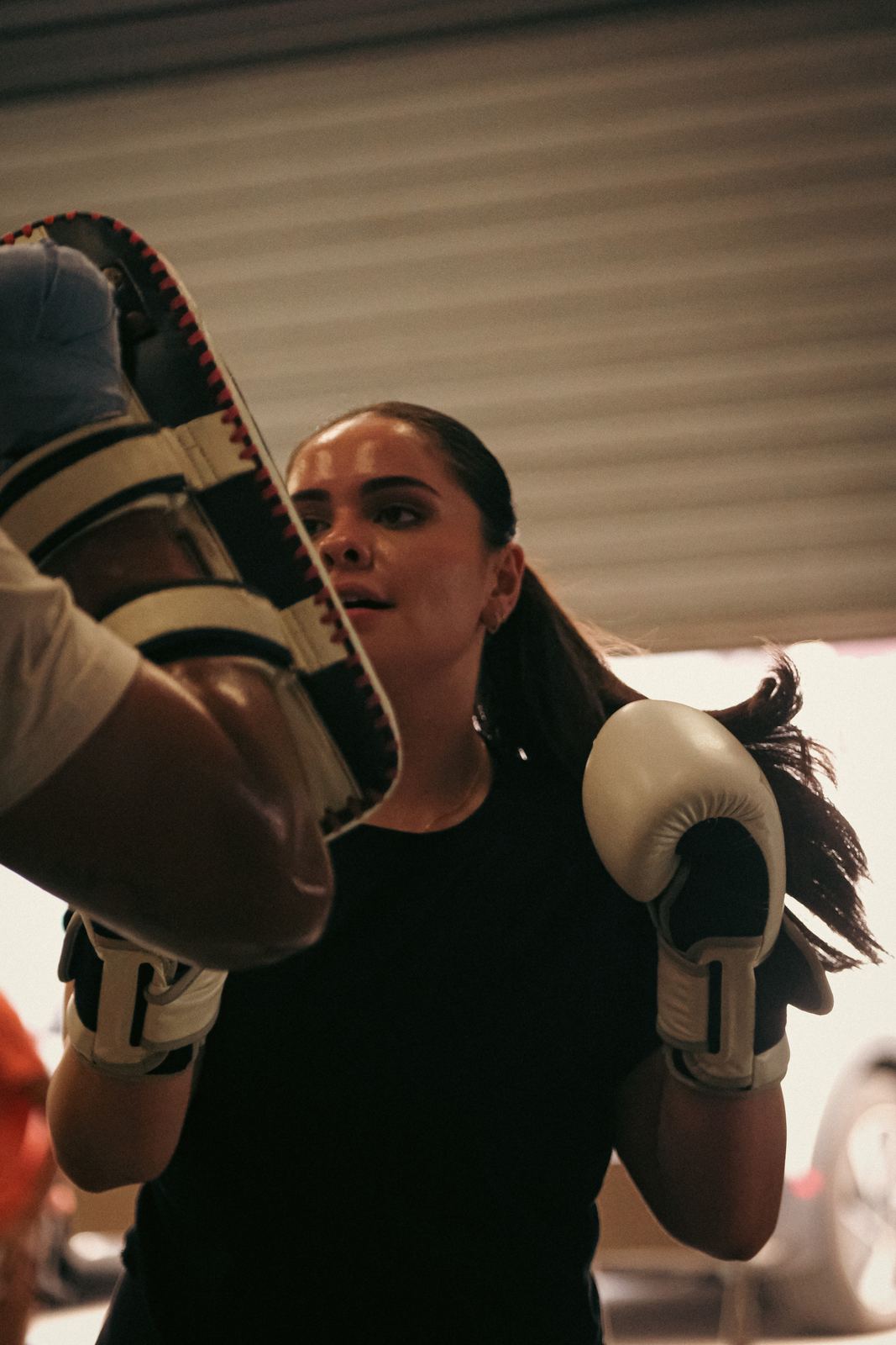 Fighter striking pads held by a coach
