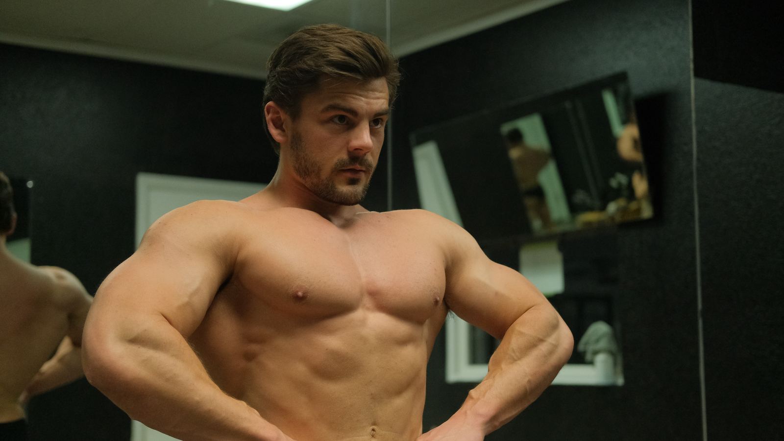 Bodybuilder posing in front of the mirror