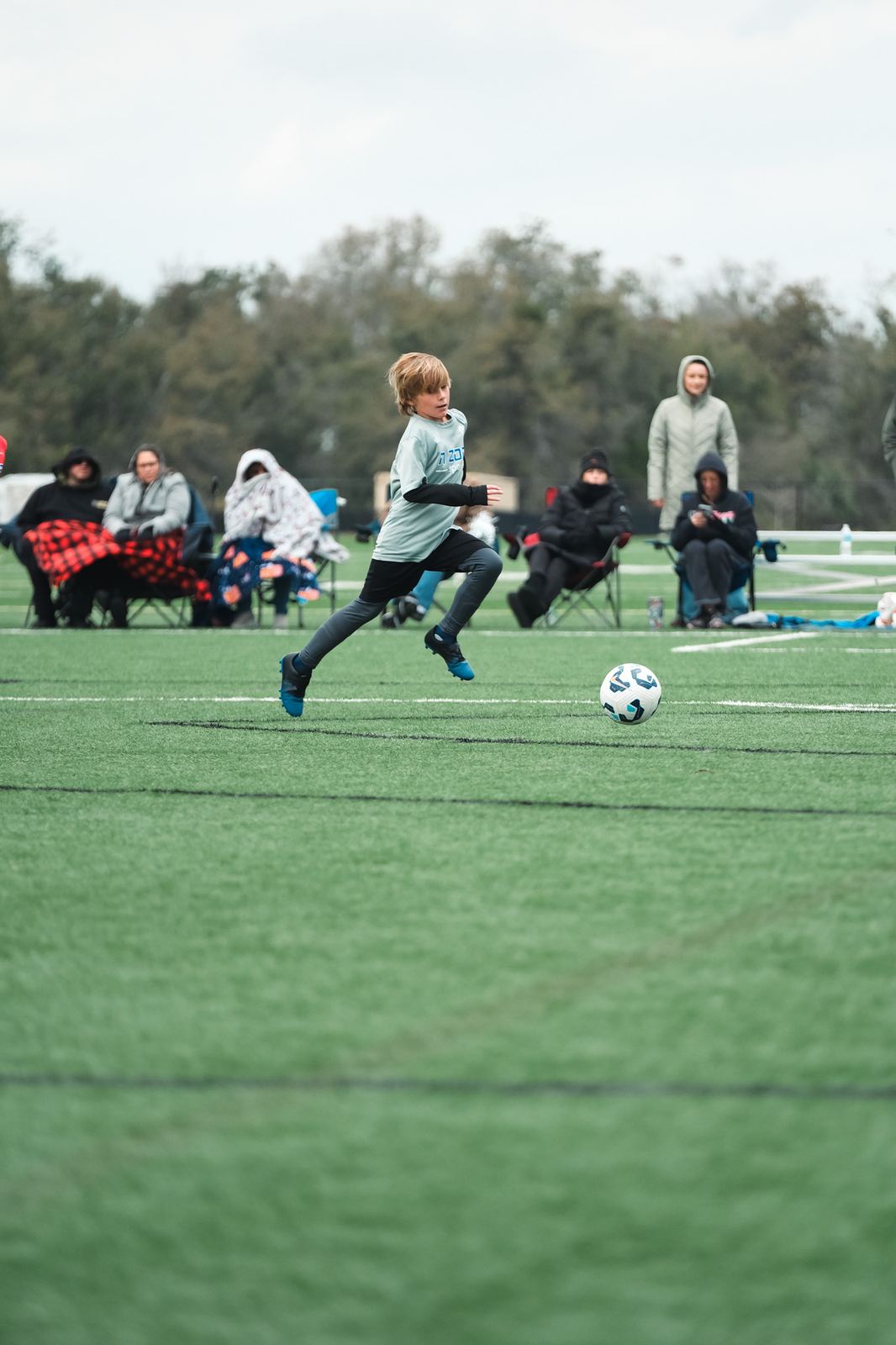 Players competing on an outdoor soccer field